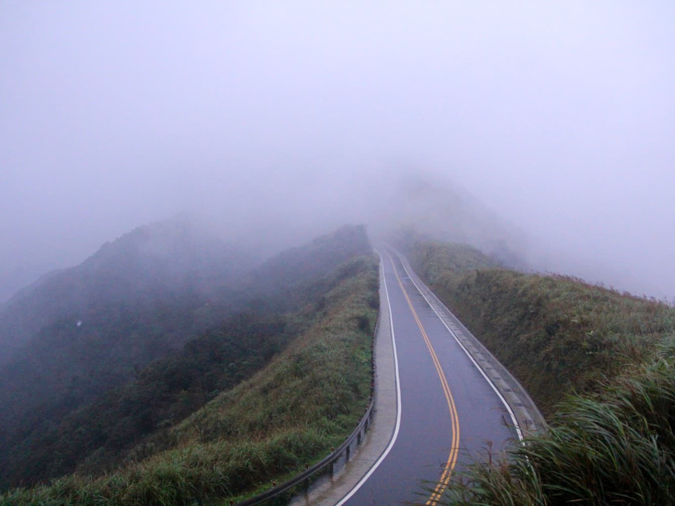 A mountain road disappearing into mist in Taiwan