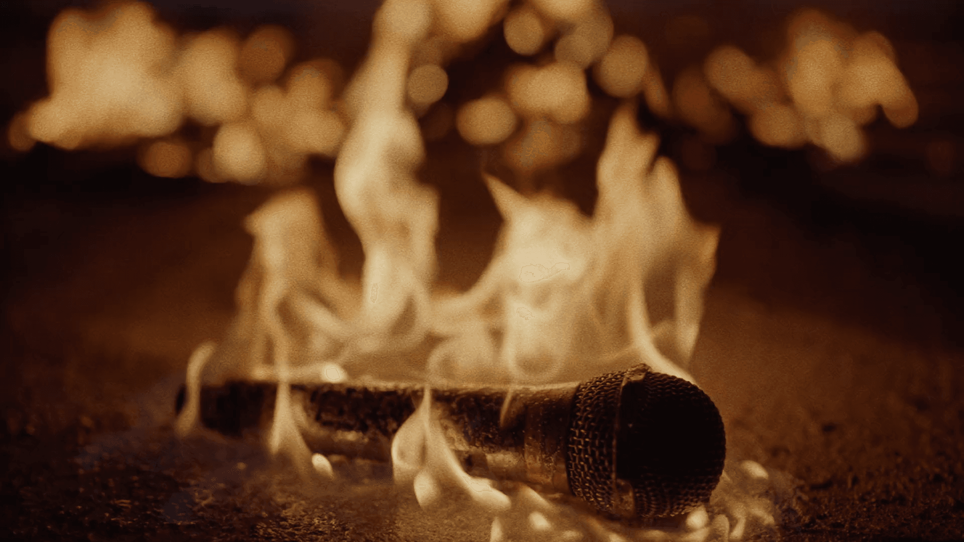 A microphone surrounded by flames from Megan Chen's production work
