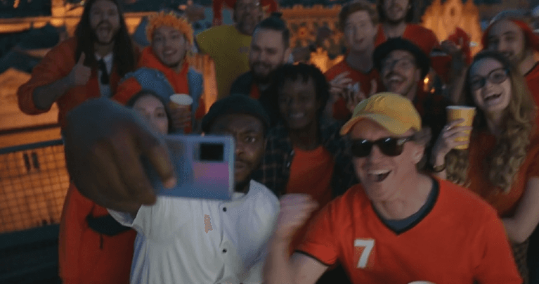 Football supporters celebrating together in a stadium